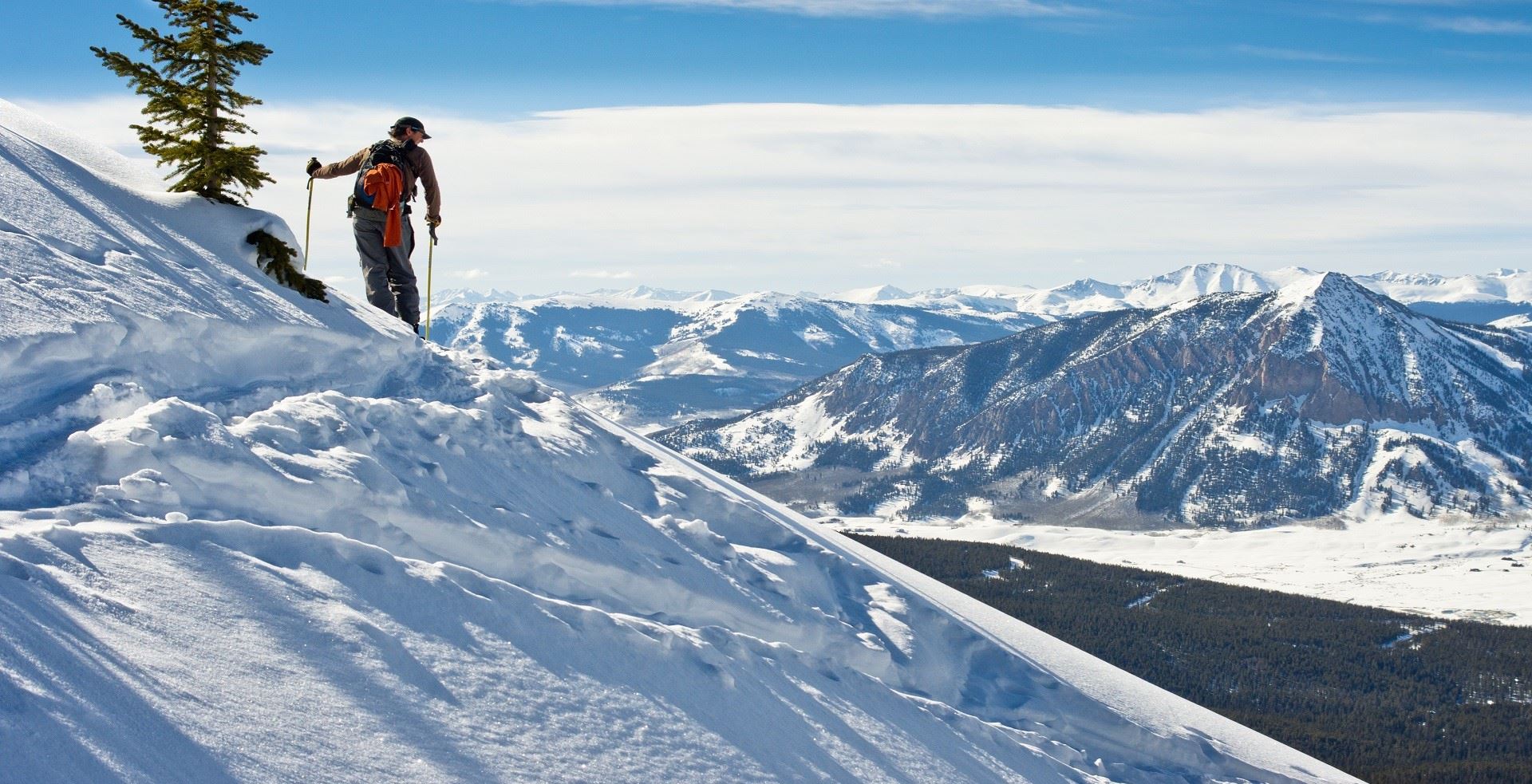 man Hiking on snow covered mountain