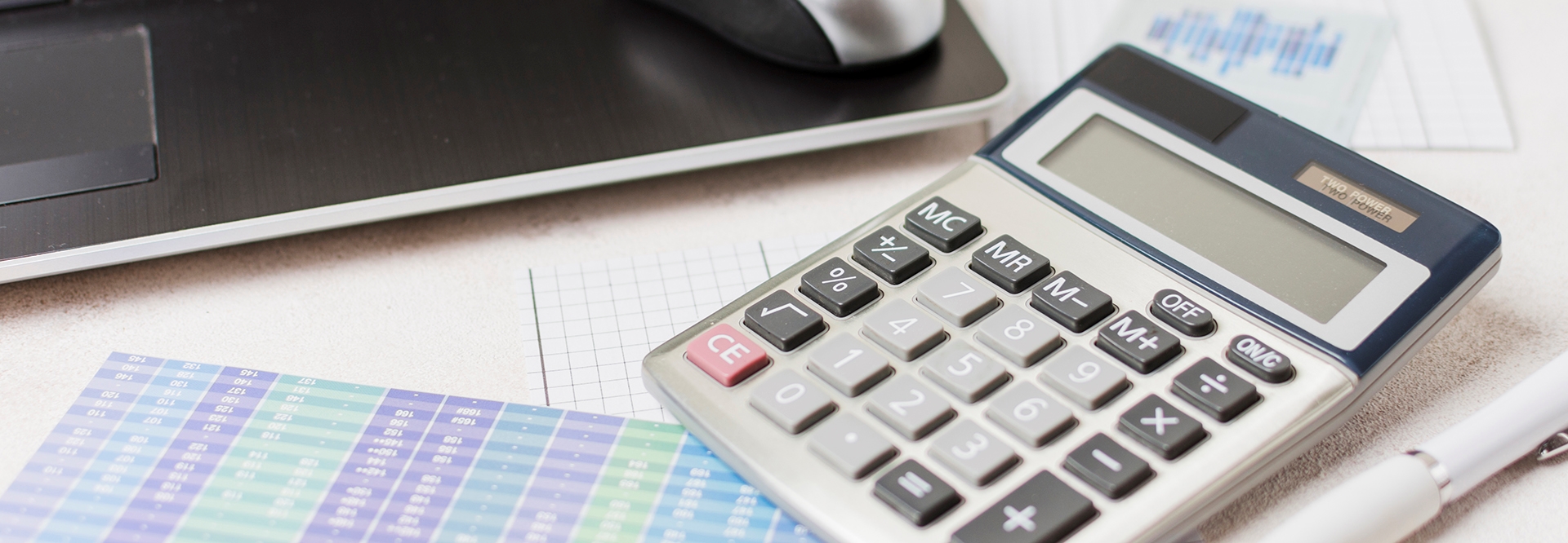 calculator on table with laptop