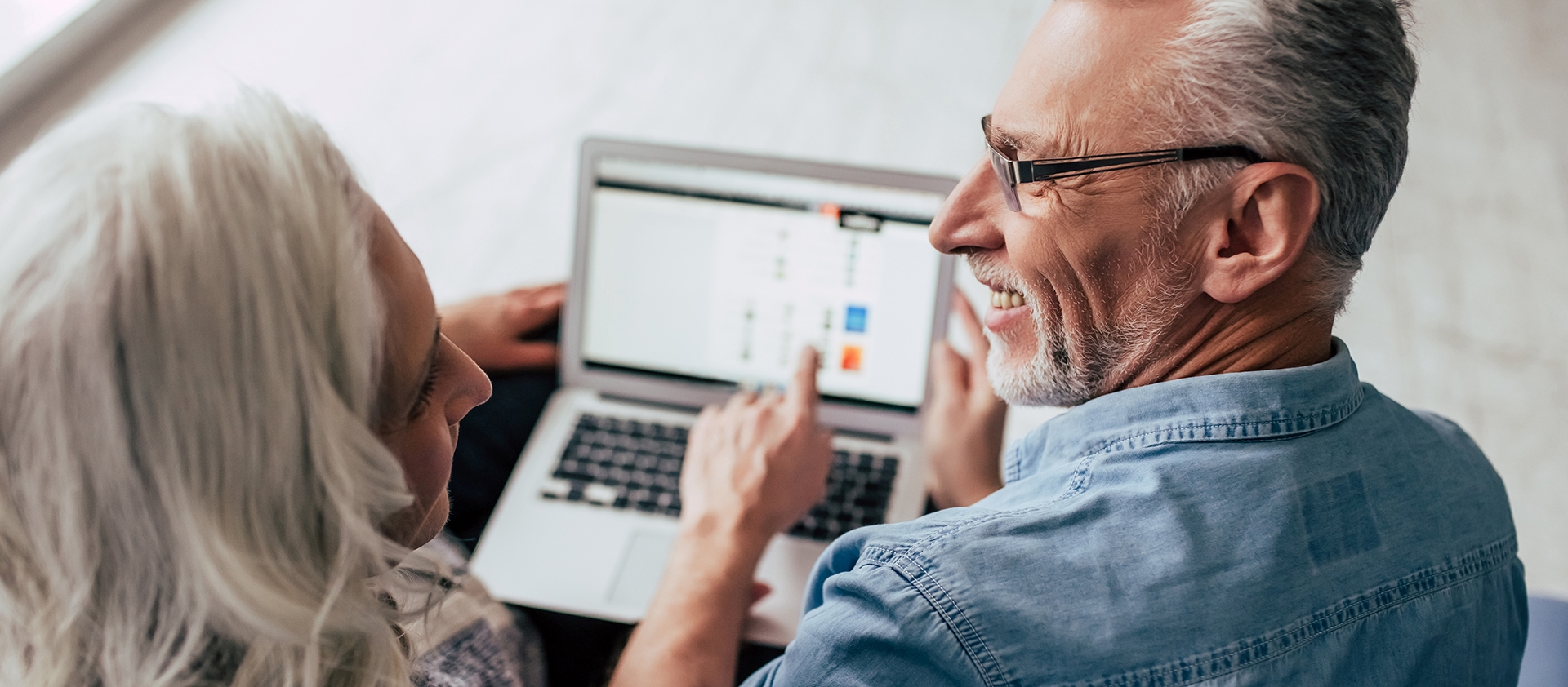 man and woman sitting at computer