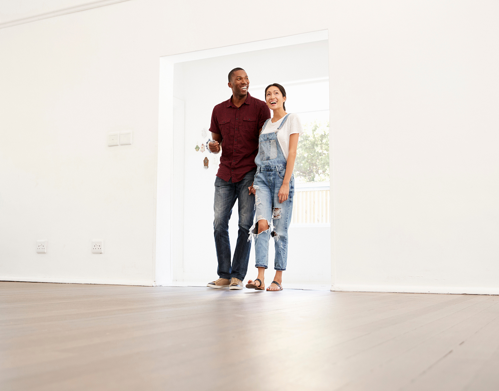 man and woman walking into a home